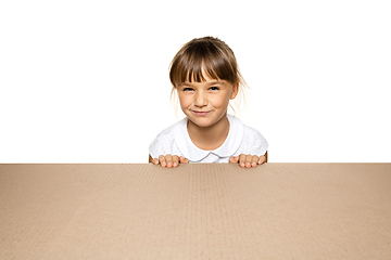 Image showing Cute little girl opening the biggest postal package