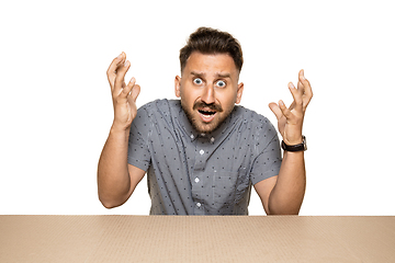 Image showing Shocked man opening the biggest postal package