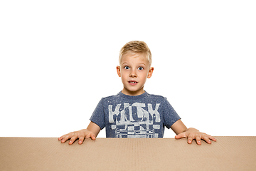 Image showing Cute little boy opening the biggest postal package