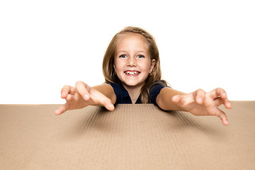 Image showing Cute little girl opening the biggest postal package