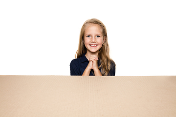 Image showing Cute little girl opening the biggest postal package