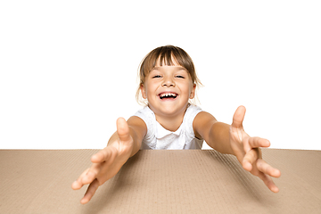 Image showing Cute little girl opening the biggest postal package