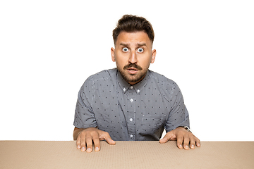 Image showing Shocked man opening the biggest postal package