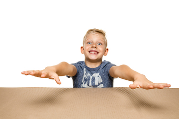 Image showing Cute little boy opening the biggest postal package