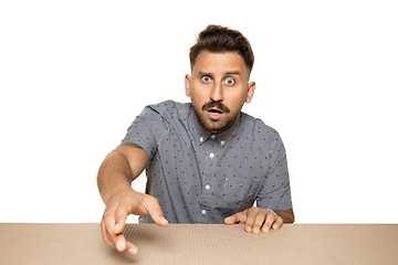 Image showing Shocked man opening the biggest postal package