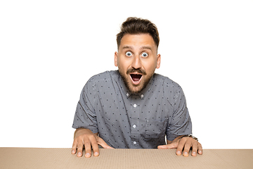 Image showing Shocked man opening the biggest postal package