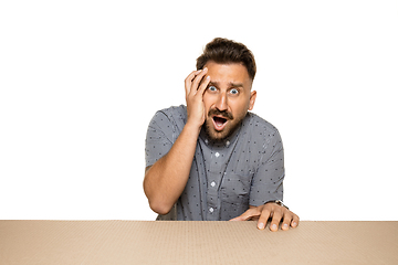 Image showing Shocked and upset man opening the biggest postal package