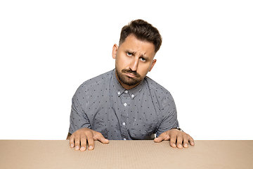 Image showing Shocked and upset man opening the biggest postal package