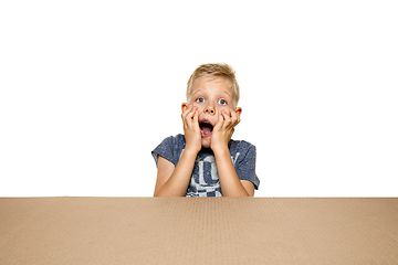 Image showing Cute little boy opening the biggest postal package