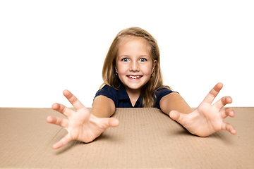 Image showing Cute little girl opening the biggest postal package