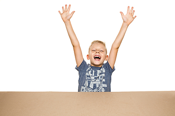 Image showing Cute little boy opening the biggest postal package