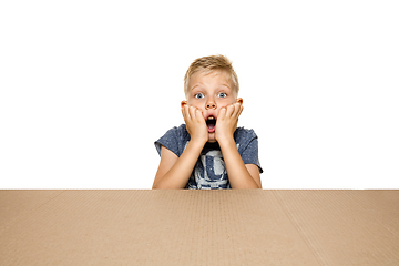 Image showing Cute little boy opening the biggest postal package