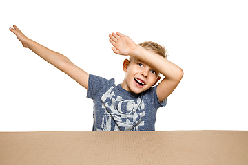 Image showing Cute little boy opening the biggest postal package