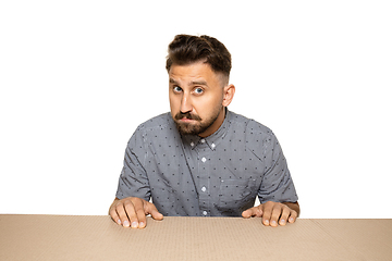 Image showing Shocked and upset man opening the biggest postal package