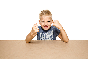 Image showing Cute little boy opening the biggest postal package