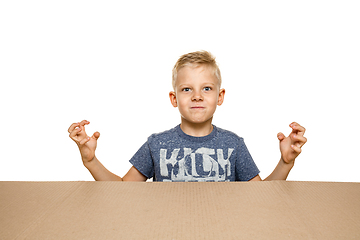 Image showing Cute little boy opening the biggest postal package
