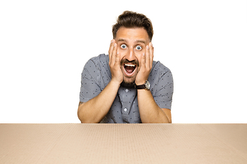 Image showing Shocked man opening the biggest postal package