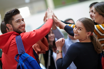 Image showing students together in problem, arm in the air