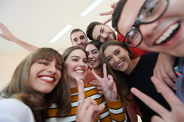 Image showing Group of multiethnic teenagers taking a selfie in school