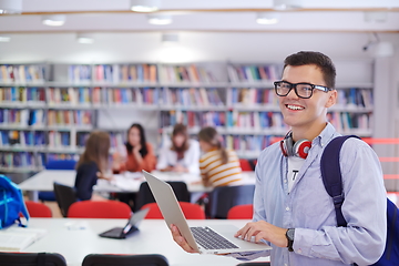 Image showing the student uses a notebook, latop and a school library