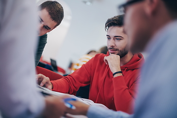 Image showing students group working on school project together on tablet computer at modern university