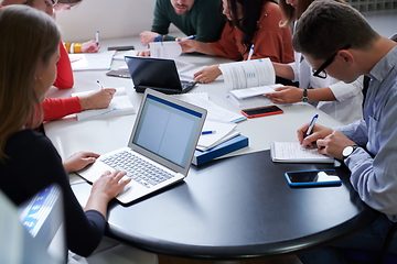 Image showing students group working on school project together on tablet computer at modern university