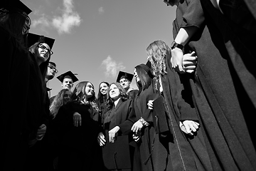 Image showing Group of diverse international graduating students celebrating