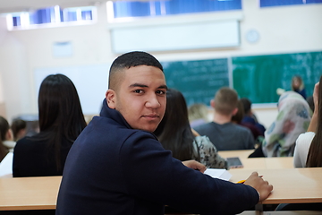 Image showing student taking notes while studying in high school