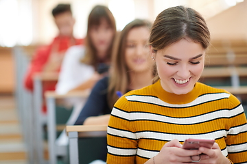 Image showing famel students using smartphone in classroom