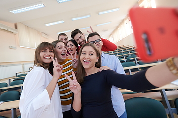 Image showing Group of multiethnic teenagers taking a selfie in school