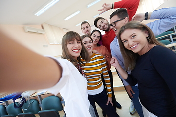 Image showing Group of multiethnic teenagers taking a selfie in school