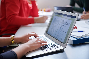 Image showing students group working on school project together on tablet computer at modern university