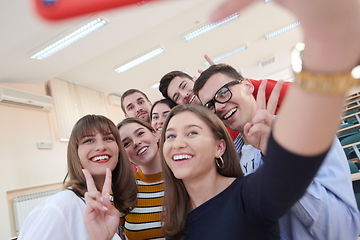 Image showing Group of multiethnic teenagers taking a selfie in school