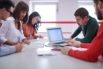 Image showing students group working on school project together on tablet computer at modern university