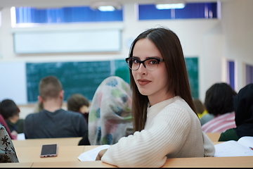 Image showing girl sitting in an amphitheater and talking to her colleagues