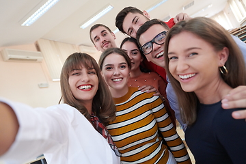 Image showing Group of multiethnic teenagers taking a selfie in school