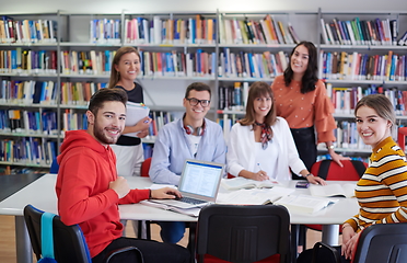 Image showing students group working on school project together on tablet computer at modern university