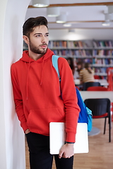 Image showing the student uses a laptop and a school library