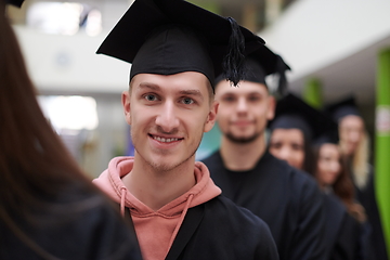 Image showing Group of diverse international graduating students celebrating