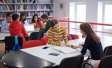 Image showing students group working on school project together on tablet computer at modern university