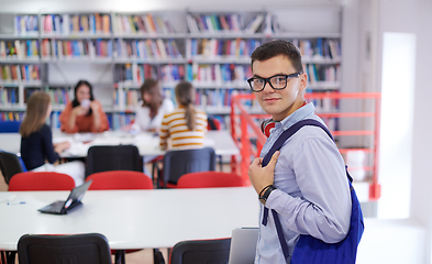 Image showing the student uses a notebook, latop and a school library