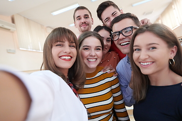 Image showing Group of multiethnic teenagers taking a selfie in school