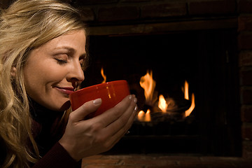 Image showing Soup or coffee by the fire