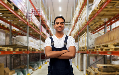 Image showing happy indian worker with crossed arms at warehouse