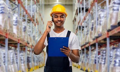 Image showing indian worker calling on smartphone at warehouse