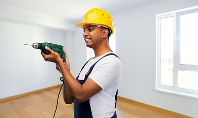 Image showing happy indian builder in helmet with electric drill