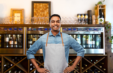 Image showing smiling indian barman or waiter at wine bar