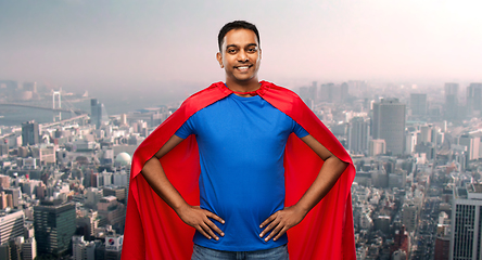 Image showing happy indian man in superhero cape in tokyo city