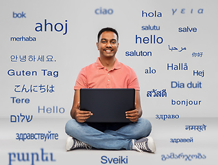 Image showing happy indian man with laptop computer on floor