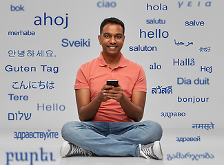 Image showing happy indian man using smartphone